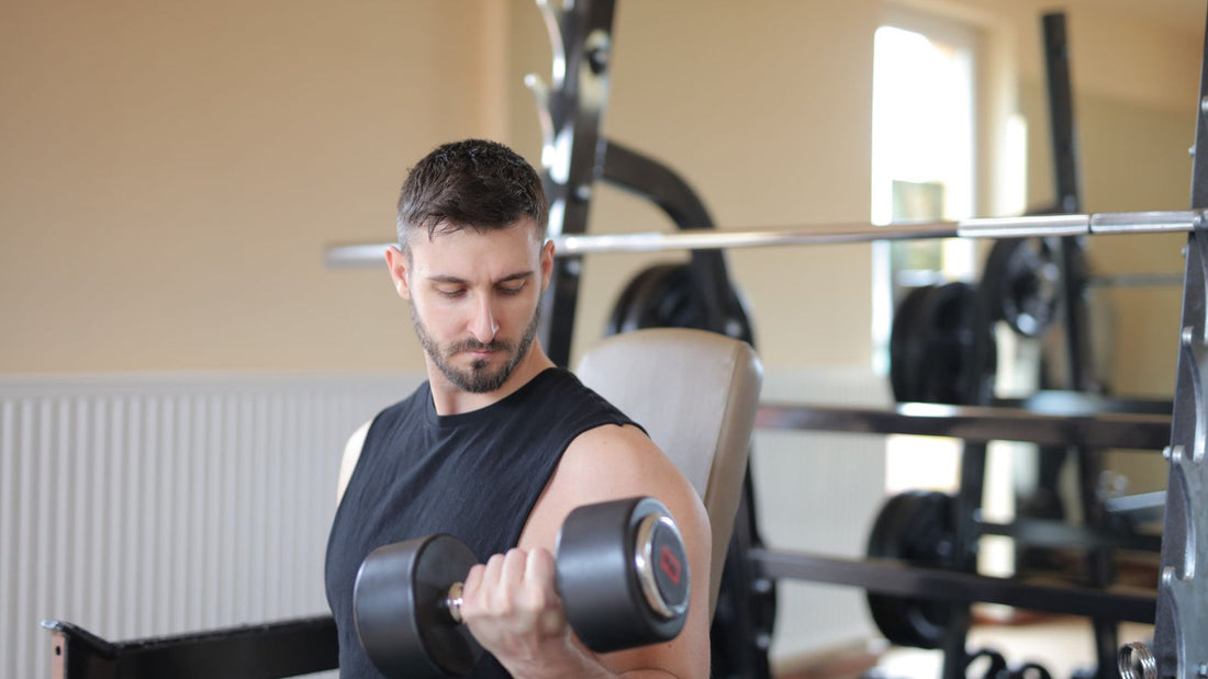 Person lifting dumbbells during a strength training session in a gym