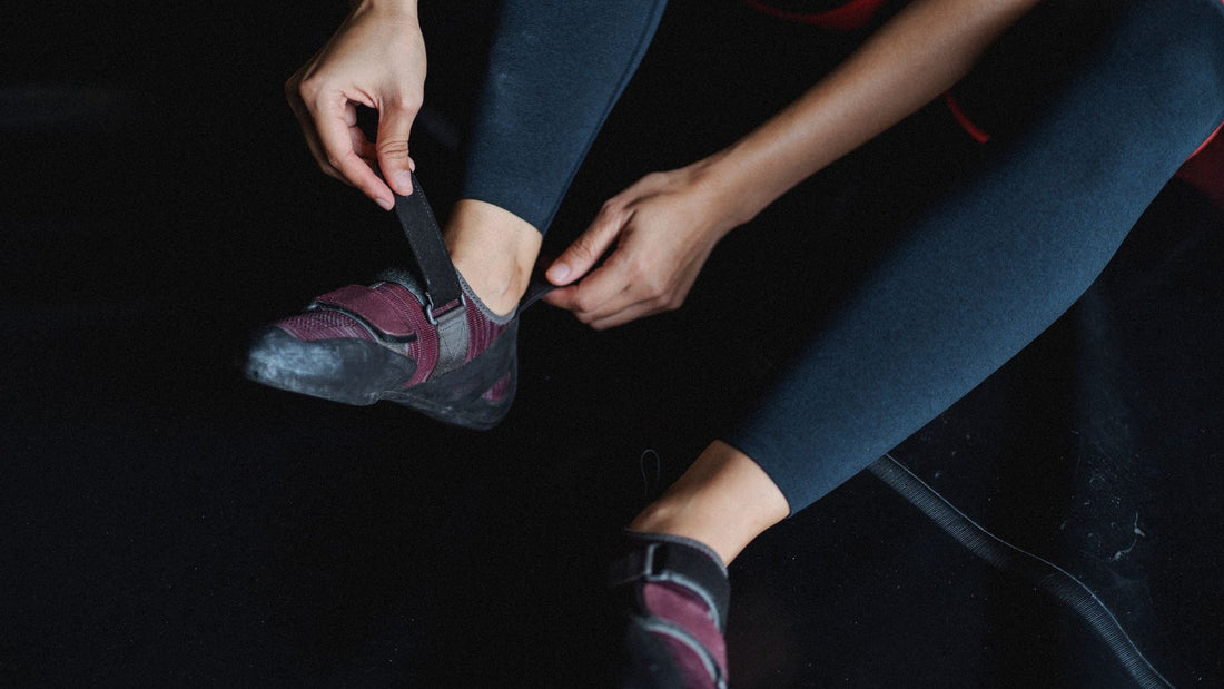 Person tightening a wrist wrap before a training session in a gym
