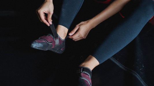 Person tightening a wrist wrap before a training session in a gym