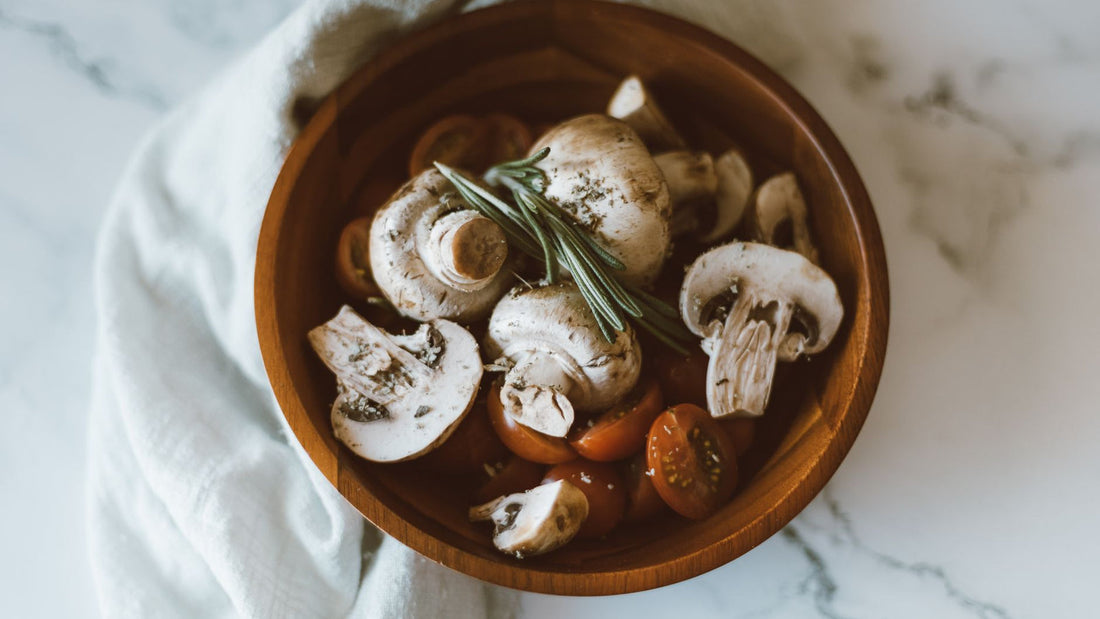 Dried mushrooms and powder arranged in a wooden bowl on a table