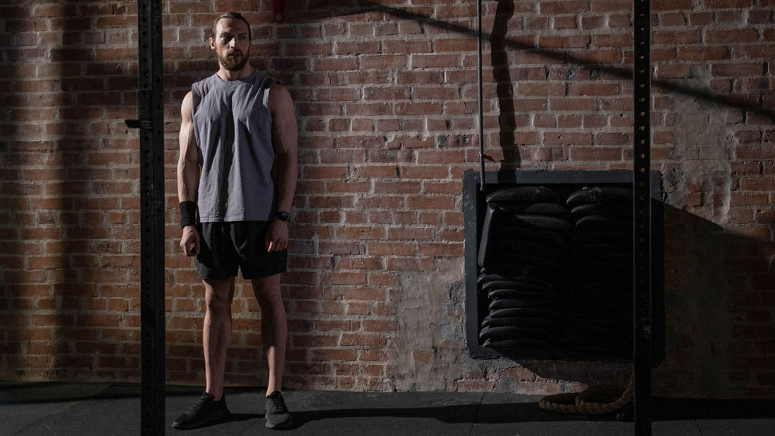 Person lifting a barbell during a strength training session in a gym